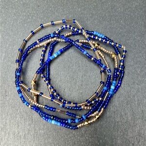 Golden and deep blue color beaded bracelet stack of 6 separate on rubber band